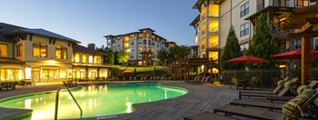 Pool with seating and umbrellas at mirabelle apartments in mobile, al